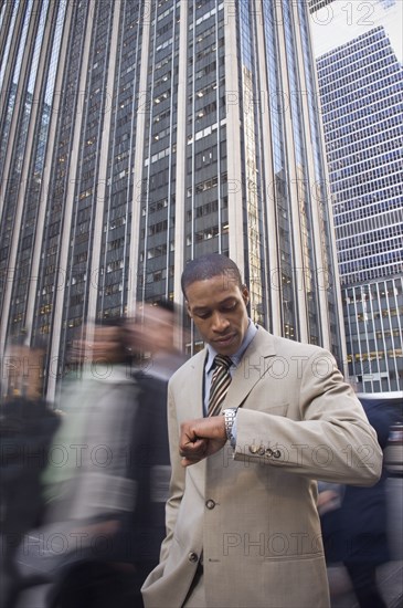 African American businessman checking watch