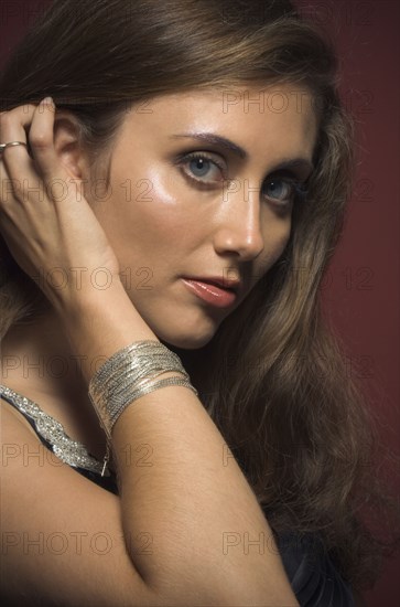 Close up of Hispanic woman with hand in hair