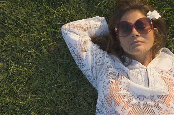 High angle view of woman sleeping in grass