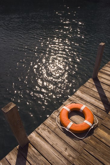 Round life preserver on wooden dock