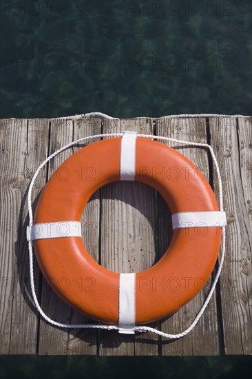 Round life preserver on wooden dock