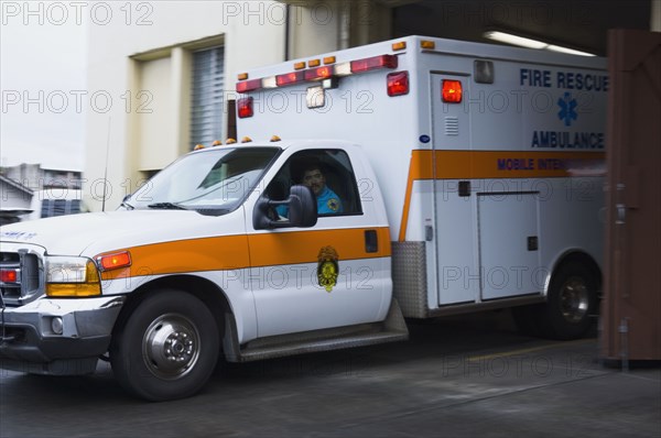 Asian male paramedic driving ambulance