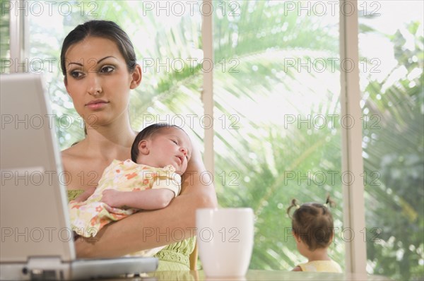 Hispanic mother holding baby