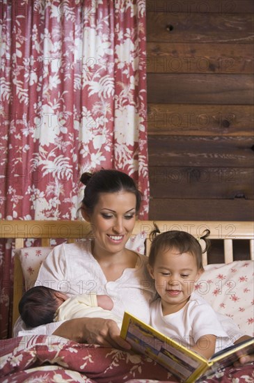 Hispanic mother reading to daughter