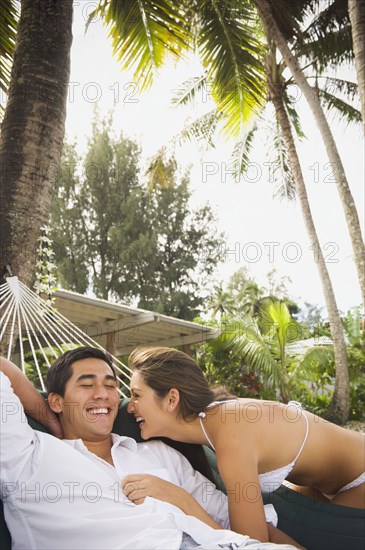 Multi-ethnic couple laughing on beach