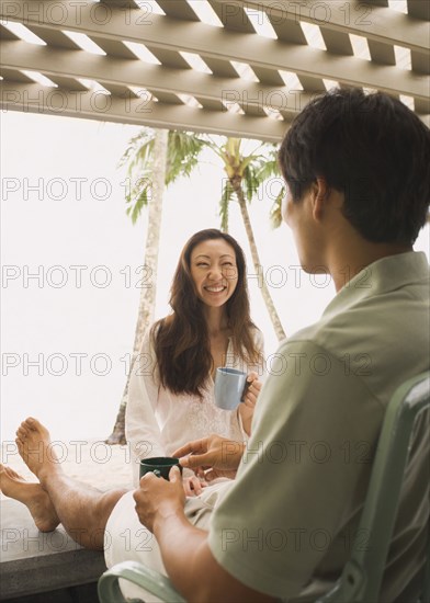 Asian couple drinking coffee