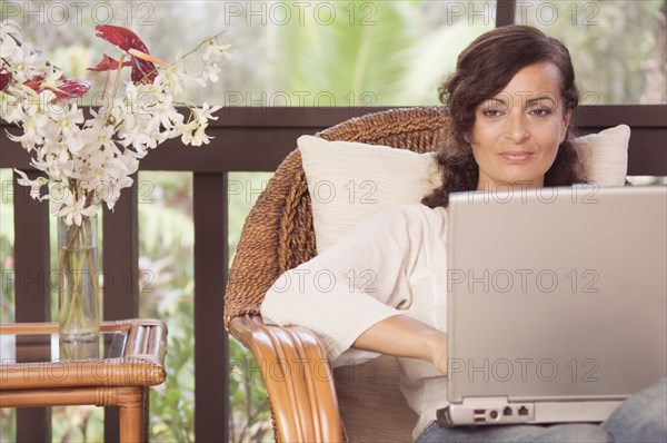 Mature woman typing on laptop