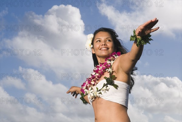 Pacific Islander woman in lei dancing