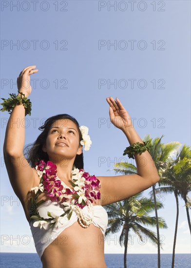 Pacific Islander woman in lei dancing