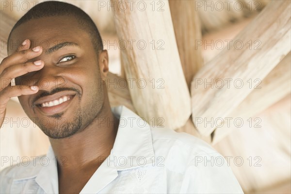 African American man with hand covering eye