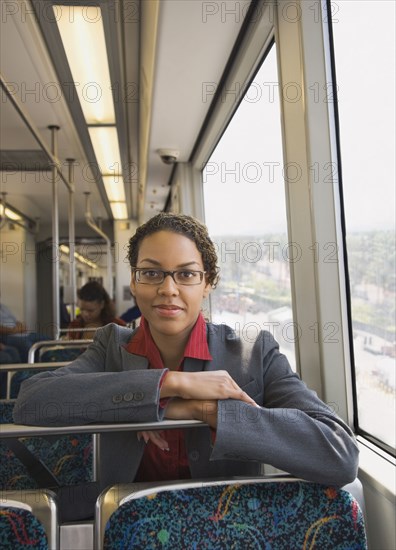 African businesswoman riding on train