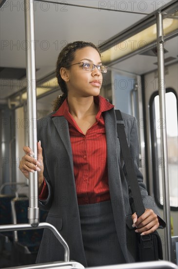 African businesswoman riding on train