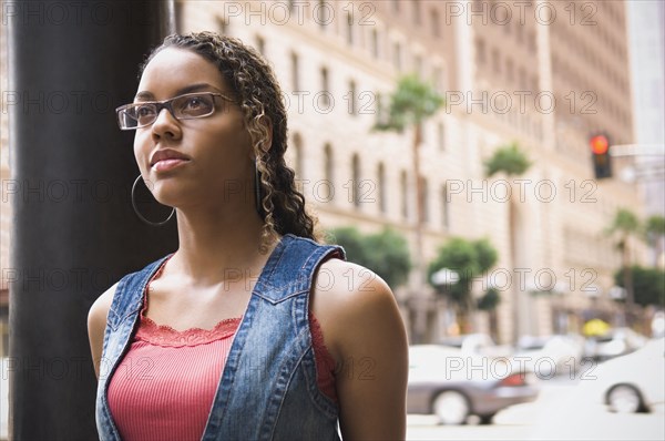 African woman standing on sidewalk