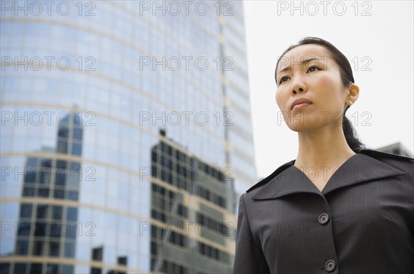Asian businesswoman in front of high-rise