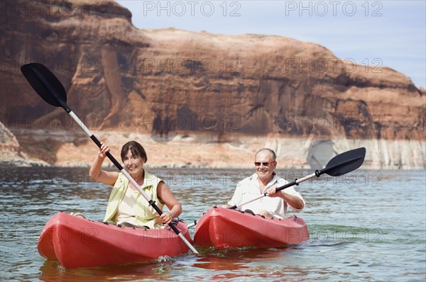 Multi-ethnic senior couple kayaking