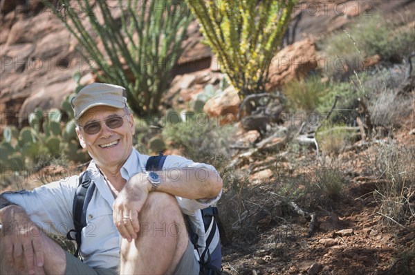 Senior man sitting on ground