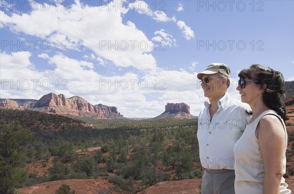 Multi-ethnic senior couple looking at desert landscape