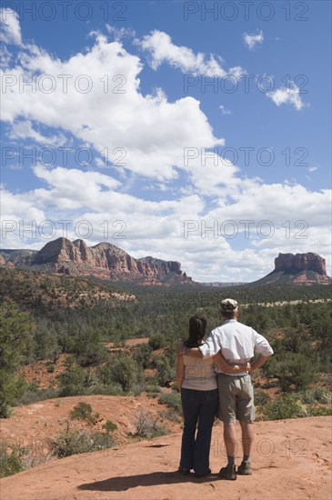 Multi-ethnic senior couple looking at desert landscape