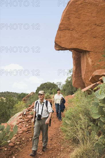 Multi-ethnic senior couple hiking in desert