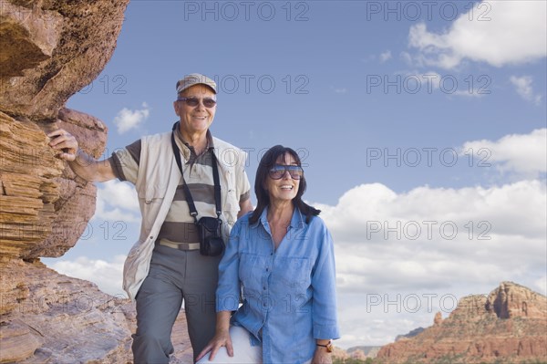 Multi-ethnic senior couple next to rocks