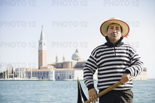 Italian gondolier with church in background