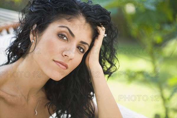 Serious mixed race woman with head in hands