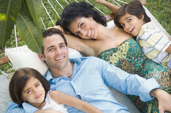 Family relaxing in hammock