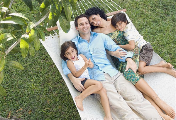 Family relaxing in hammock