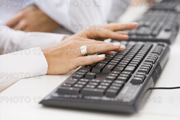 Hispanic woman typing on keyboard