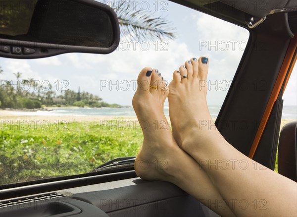 Woman with feet up in car