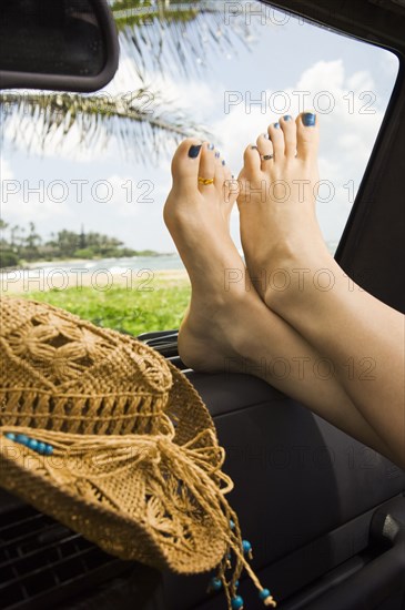 Woman with feet up in car