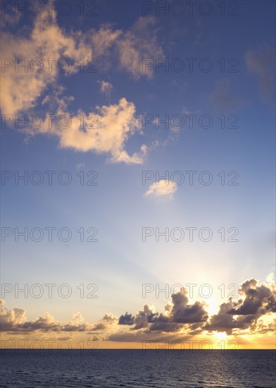 Sun setting over ocean