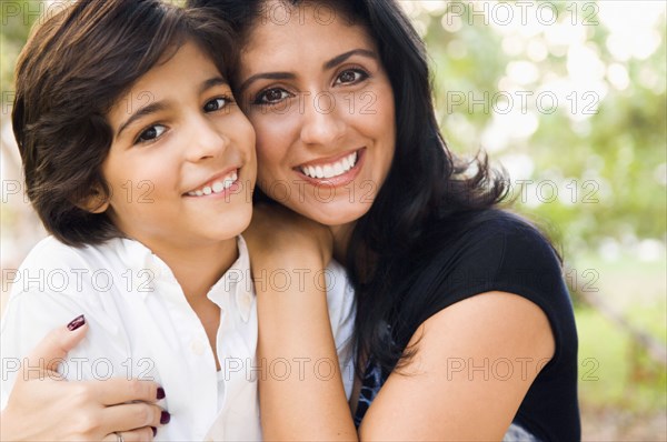 Mixed race mother hugging son