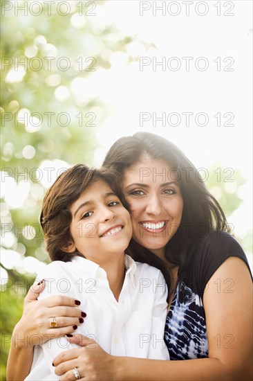 Mixed race mother hugging son
