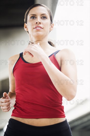 Hispanic woman running in urban area