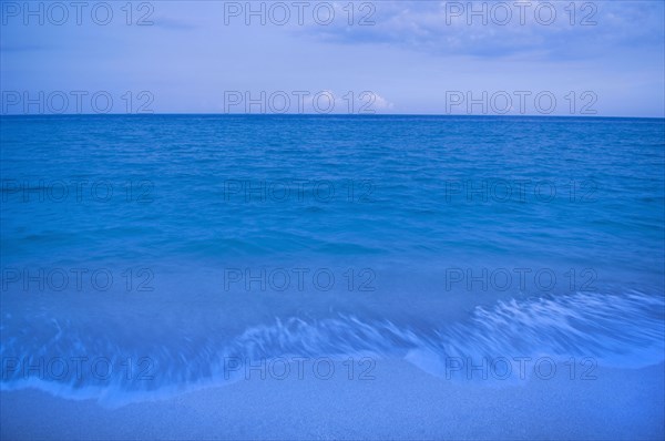 Waves on beach of tranquil blue ocean