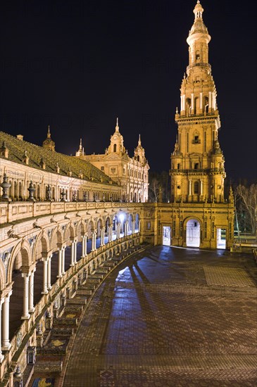 Bell tower and ornate porticoed building at night