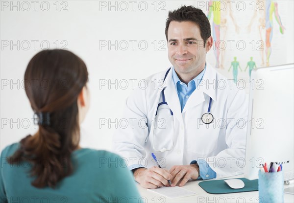 Doctor sitting at desk with patient