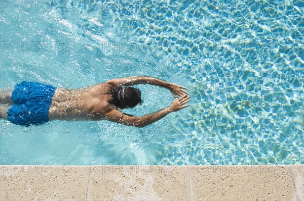 Caucasian man swimming in pool