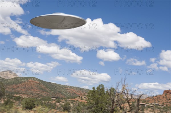 UFO flying over desert