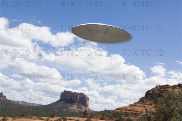 UFO flying over desert