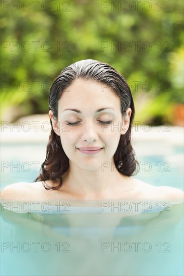 Caucasian woman enjoying swimming pool