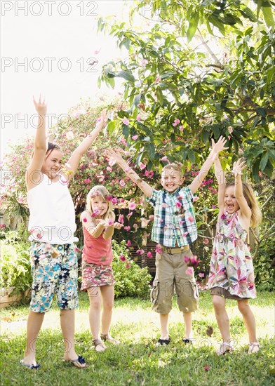 Caucasian children playing in garden