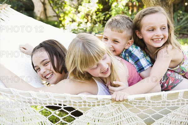 Caucasian children playing in tree