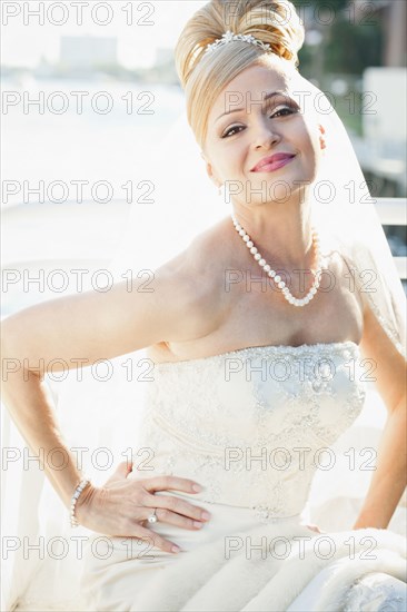 Hispanic bride with hands on hips