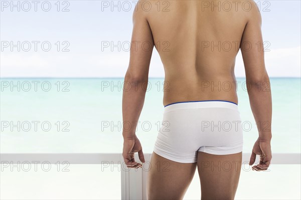 Hispanic man wearing white underwear