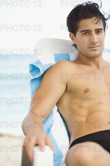 Caucasian man relaxing in lawn chair