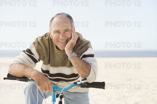 Caucasian man sitting on bicycle