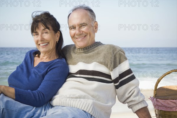 Couple relaxing at picnic on beach