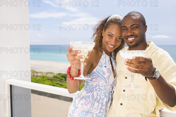 Couple having drinks on balcony
